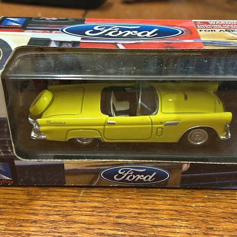 Yellow diecast convertible car with black interior, in Ford blister package