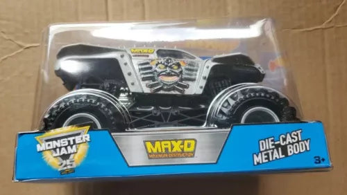 Die-cast monster truck MAX-D in retail box, black and silver body with Monster Jam graphics.
