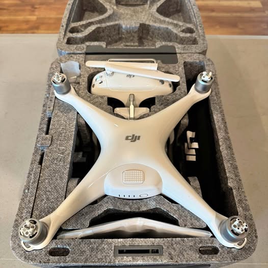 DJI Phantom 4 drone with beige body in hard case, front camera visible