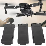 Three black rectangular drone battery packs with mounting tabs