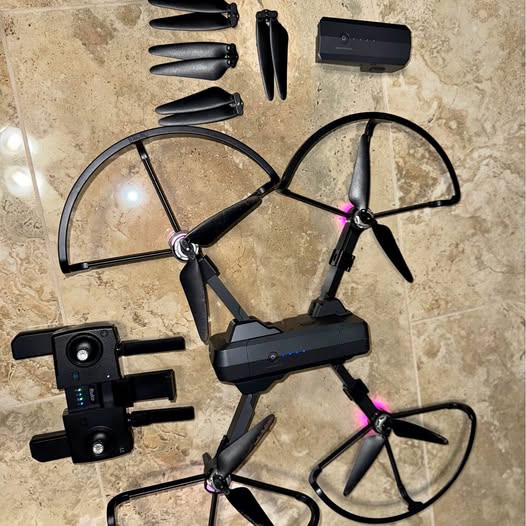 Foldable quadcopter drone with four propellers and two attached cameras