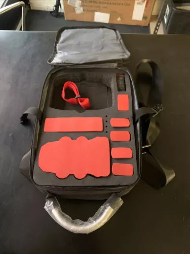 Small drone storage bag with gray interior and red foam cutout compartments