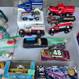 Die-cast vehicle set with trucks, race car, and classic vehicles in display box