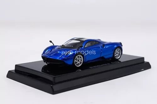 Blue diecast sports car model with black hood on display base, 1:64 scale.