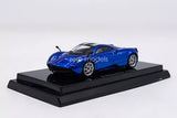 Blue diecast sports car model with black hood on display base, 1:64 scale.