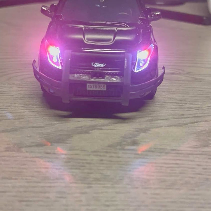 1/24 diecast car front view in purple with illuminated headlights and grille