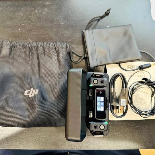 DJI wireless microphone kit with transmitter, receiver, cables, and carrying pouch