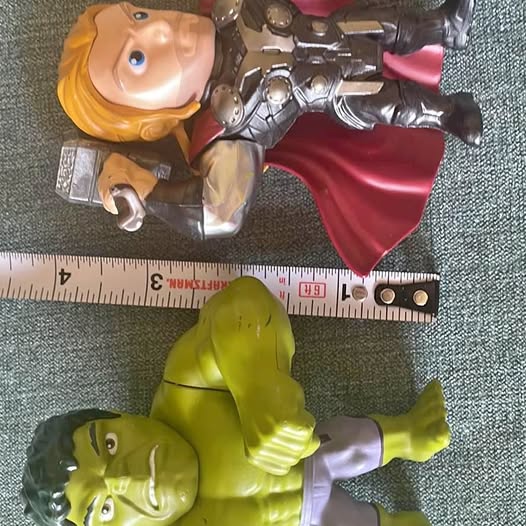 Green muscular die-cast action figure with white pants and raised arms