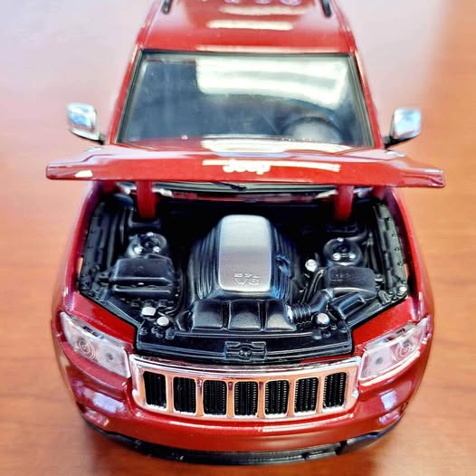 Red 1/24 diecast SUV model with open hood, detailed engine, chrome grille