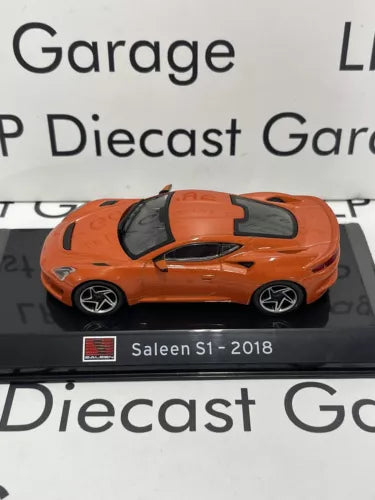 Orange diecast supercar model with black hood stripe, front 3/4 view, display base