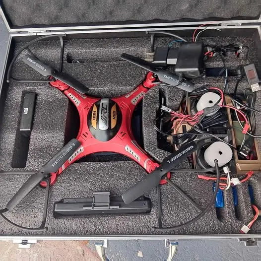 Quadcopter drone with camera, black and red, packed in foam carrying case