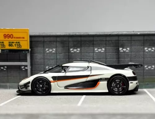1:64 scale diecast sports car model, white with black wheels and orange stripe