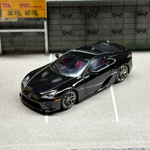 1/64 scale black diecast sports car toy, front three-quarter view