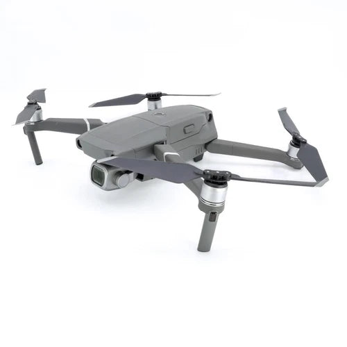 Gray quadcopter drone with front camera gimbal and four propellers.