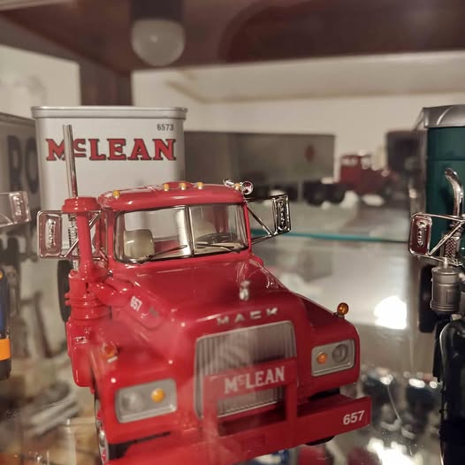 Red 1/34 scale diecast tractor truck model cab with front grille and headlights