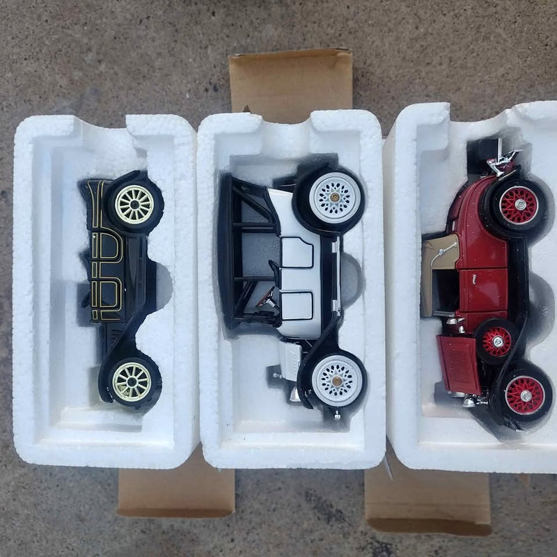 Diecast collectible car set with three cars in foam inserts