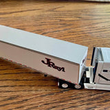 Diecast JRay tractor trailer replica with white trailer and JRay logo, front view