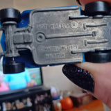 Diecast metal hot rod car chassis with embossed engine detail and screws