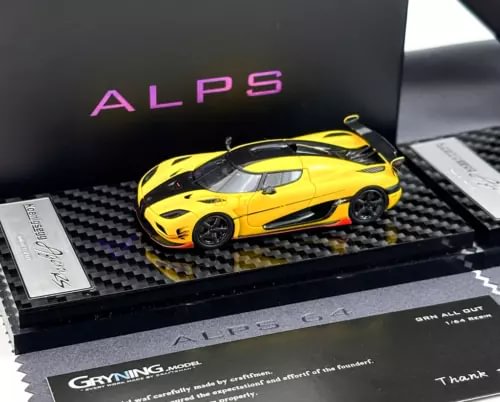 Yellow racing sports car diecast model with black wheels on display base