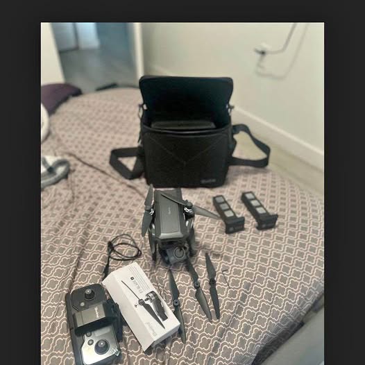 Foldable camera drone with spare controllers and carrying case, gray/black