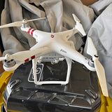Dj Phantom drone in white with red stripes and four propellers