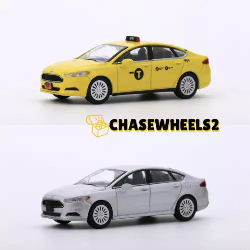 Yellow and silver diecast model car with detailed wheels and taxi markings