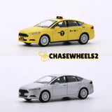 Yellow and silver diecast model car with detailed wheels and taxi markings