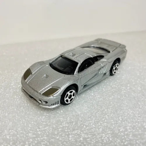 Gray 1/64 diecast model car, front 3/4 view with hood details