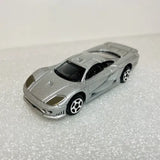 Gray 1/64 diecast model car, front 3/4 view with hood details