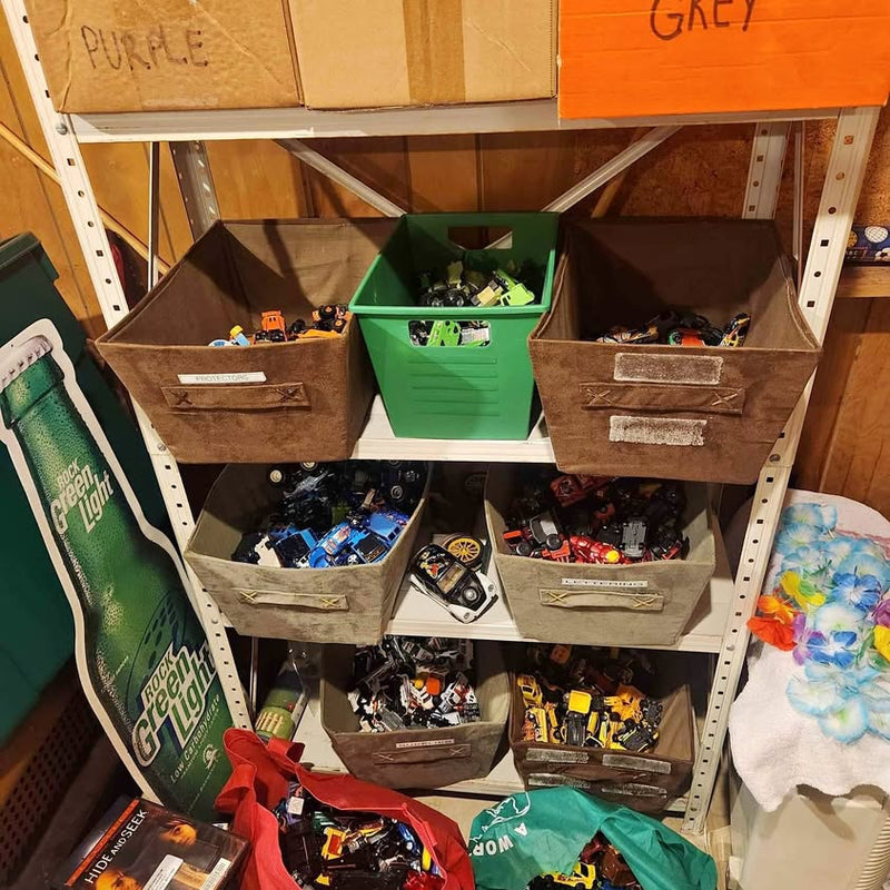 Assorted vintage diecast toy cars in storage bins on a shelf