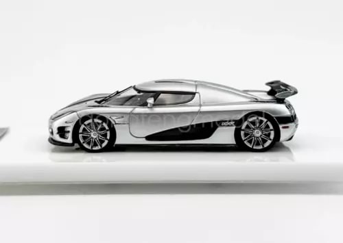 Silver 1:64 sports diecast car model with black accents, side view