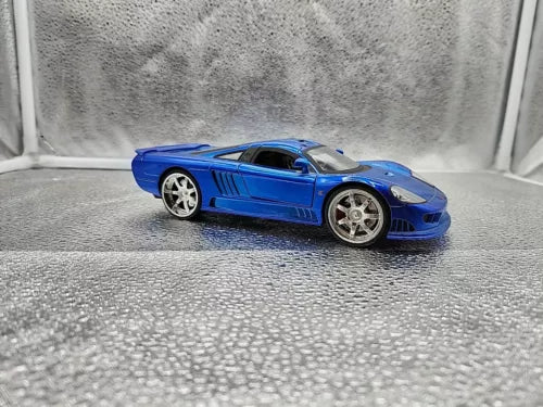 Blue 1:24 scale sports car diecast model with silver wheels, front-side angle