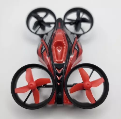 Mini red quadcopter drone with four propellers and black guards