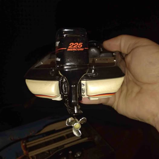 Diecast boat model with black hull, yellow side panels, and front 225 sticker