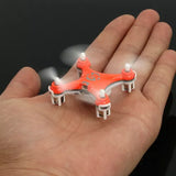 Mini LED quadcopter RC drone with orange body, four spinning rotors, white landing legs