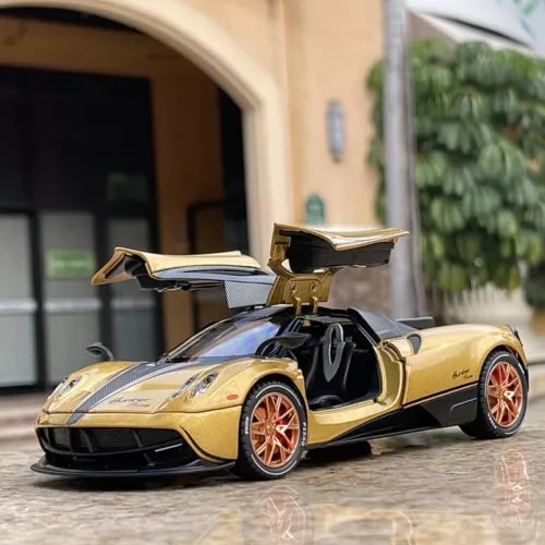 Gold and black diecast supercar toy with open scissor doors, front 3/4 view