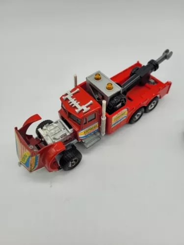 Red diecast wrecker towing truck with crane boom and front winch detail