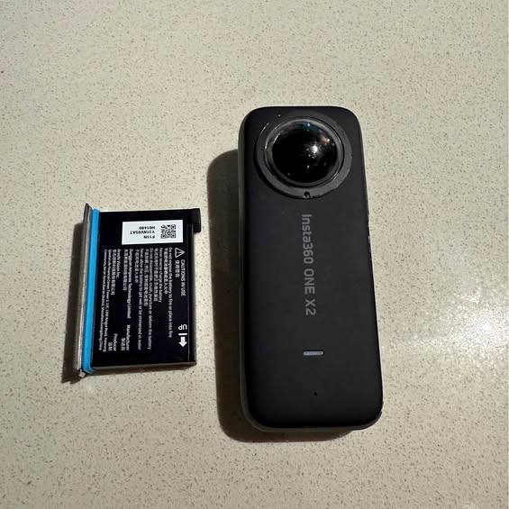 Black Insta360 One X2 action camera with front lens and side indicator
