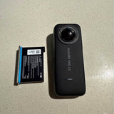 Black Insta360 One X2 action camera with front lens and side indicator