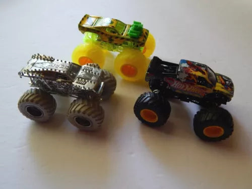 Diecast monster jam trucks set with three colorful cars and oversized wheels