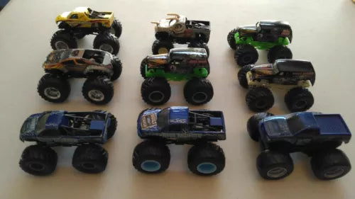1:64 diecast monster truck variety set with several toy trucks, top views.