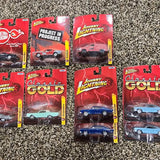 Johnny Lightning diecast car blister packs, assorted designs in red packaging
