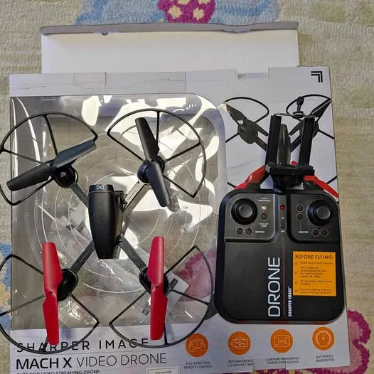 Video drone kit with remote controller, propeller arms visible in retail box
