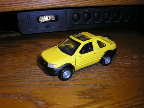 Yellow diecast Land Rover Freelander model car, front 3/4 view