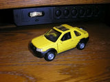 Yellow diecast Land Rover Freelander model car, front 3/4 view
