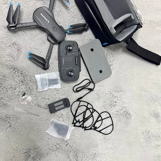 Foldable drone with controller, propellers, battery, and cables