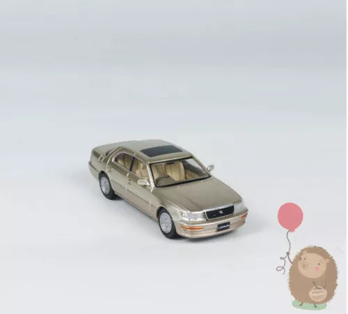 1:64 champagne alloy diecast car model with detailed grille and headlights