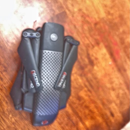 Black handheld electronic device with textured center panel and side buttons