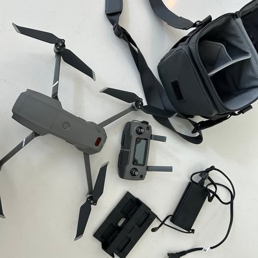 Foldable drone with camera module, propellers, and remote controller in case
