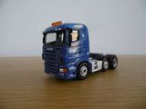 Blue diecast tractor truck with orange roof beacon and cab details